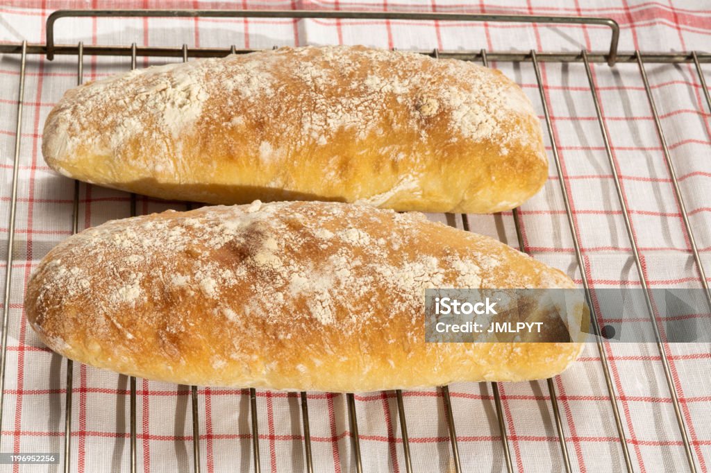 Italian bred : horizontal view Ciabatta home made Ciabatta is a white bread from Italy, one of the main features of which is both a high hydration rate and the presence of olive oil among the ingredients. This type of bread is often used as sandwich bread. Bread Stock Photo