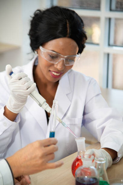 istock Scientist with equipment and science experiments, laboratory glassware containing chemical liquid for research or analyzing a sample into test tube in laboratory. 1196953249