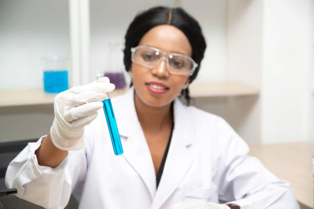 istock Scientist with equipment and science experiments, laboratory glassware containing chemical liquid for research or analyzing a sample into test tube in laboratory. 1196953255