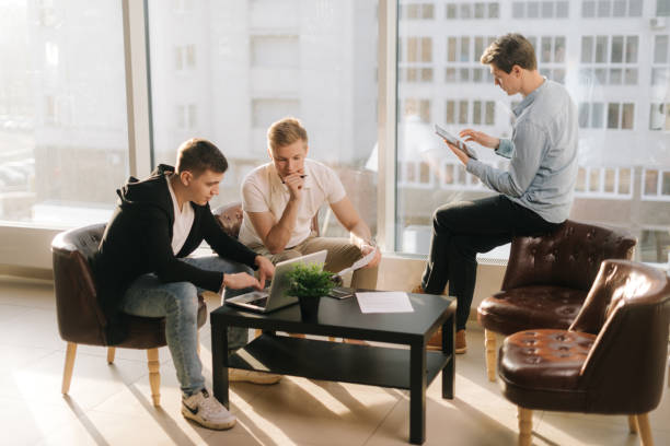 istock Creative business team of three young people discussing new project 1196956004