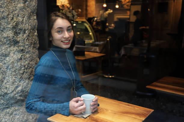 istock Young woman drinking coffee 1196958880