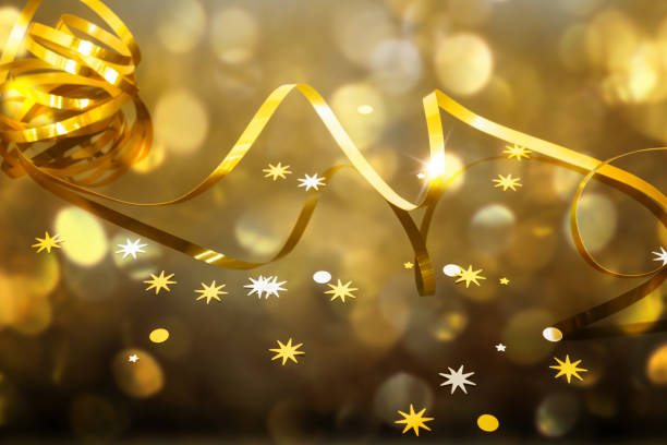 istock golden party streamer and confetti on shiny abstract background 1196959109