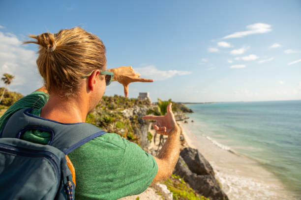 istock Young man framing Tulum ruins with hands Mexico 1196960399