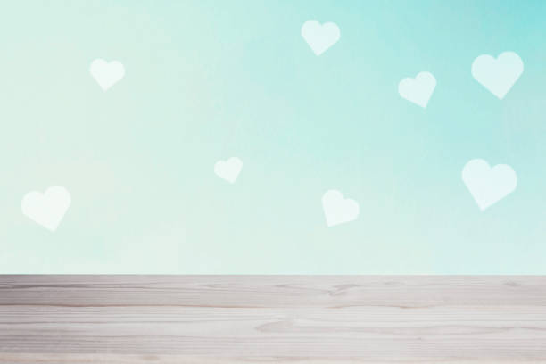 istock empty white table on the blur blue heart wall background 1196962911