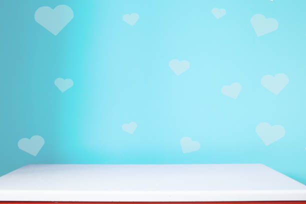 istock empty white table on the blur blue heart wall background 1196962958