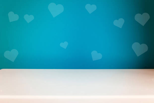 istock empty white table on the blur blue heart wall background 1196963003