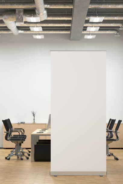 istock Blank roll up banner stand in white office interior. 1196965852