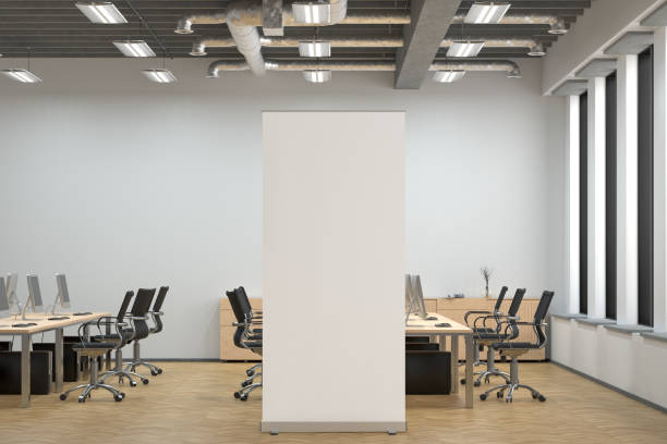 istock Blank roll up banner stand in white office interior. 1196965858