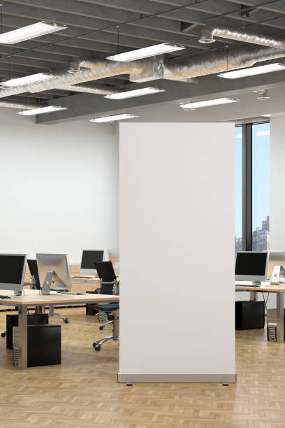 istock Blank roll up banner stand in white office interior. 1196966365