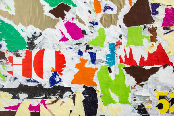 istock Old dirty torn and peeling paper posters and placards on billboard texture background. 1196966588