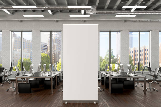 istock Blank roll up banner stand in white brick office interior 1196966886