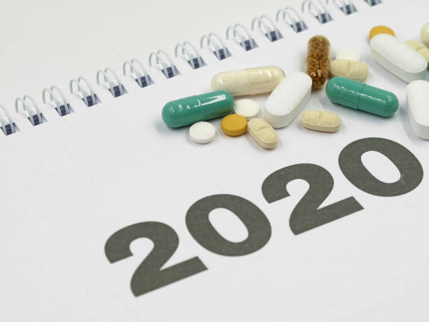 istock white calendar 2020 with various pills and copy space 1196969640