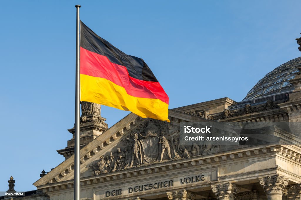 German flag fluttering front of Reichstag building. Berlin, Germany Germany Stock Photo