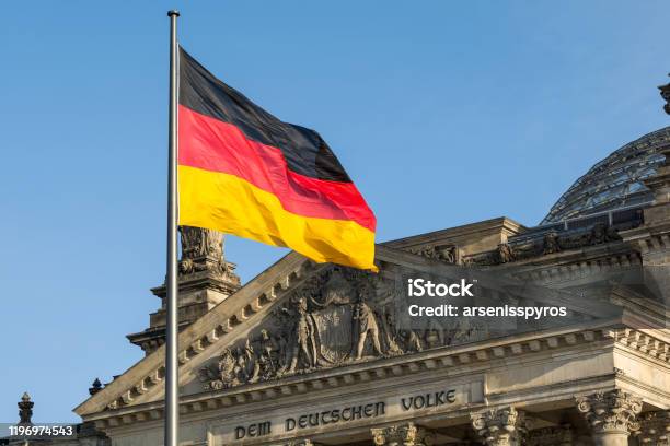 German Flag Fluttering Front Of Reichstag Building Berlin Germany Stock Photo - Download Image Now