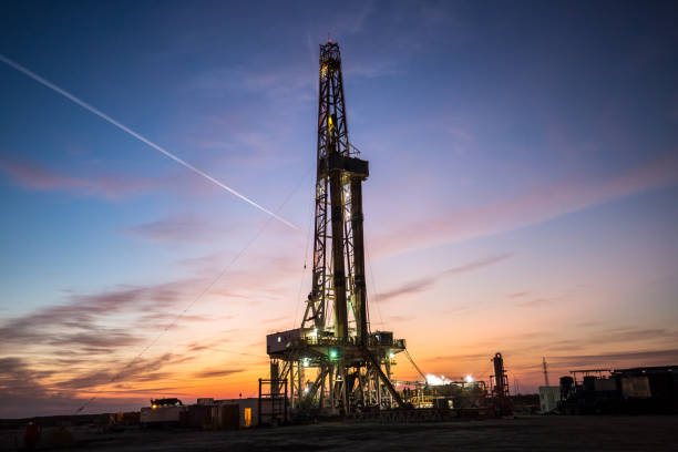 istock Oil drilling platform at sunset 1196978673