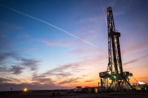 istock Oil drilling platform at sunset 1196979481