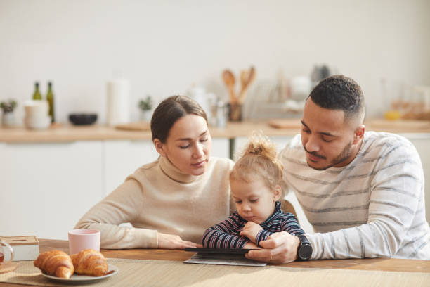 istock Modern Family Using Digital Tablet with Cute Little Girl 1196980243