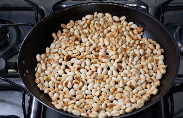 istock Roasting peanuts in the frying pan. 1196981229
