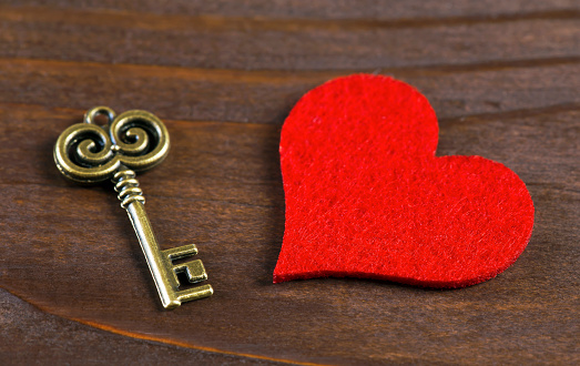 Valentines day background, red heart with vintage gold key, love concept