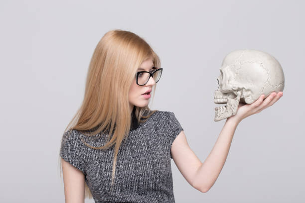 istock Young blonde smart woman holding skull 1196984566