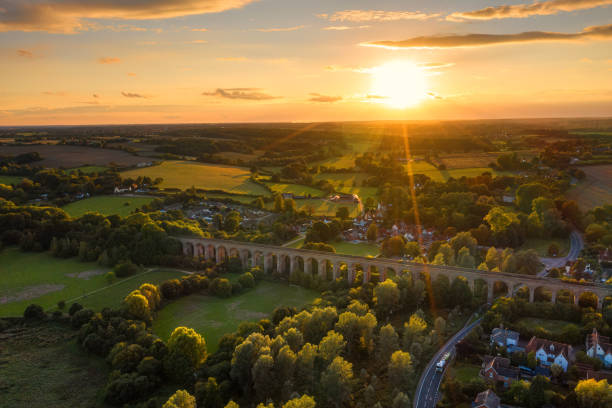 The railway viaduct at sunset in Chappel and Wakes Colne in Essex, England An aerial view of the Chappel and Wakes Colne viaduct in the English county of Essex essex england photos stock pictures, royalty-free photos & images