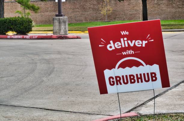 Grubhub sign posted in the ground in Humble, Texas. Humble, Texas/USA 01/01/2020: Grubhub sign posted in the ground near some local businesses in Humble, TX. Grubhub is an online fast food delivery service that is becoming increasingly popular in the US. 2004 2004 stock pictures, royalty-free photos & images