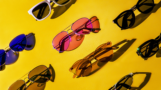 Variety of sunglasses over colorful background