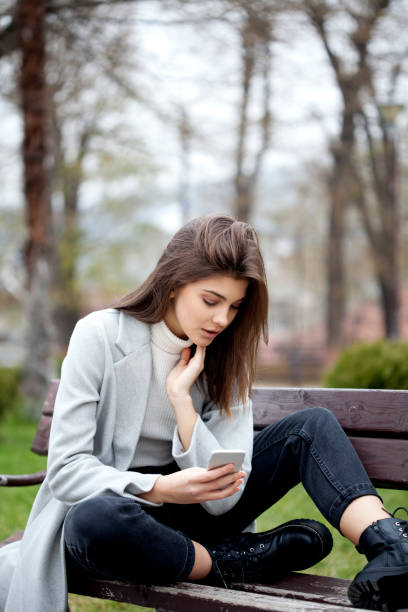 istock young woman with smart phone 1196992431