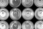 Close up photo of aluminium cans in a raw isolated on black background. Aluminium can background. Can Pattern. Aluminium beverage cans. Drink can. Metal containers for packaging drinks.