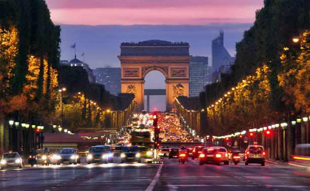 Champs Elysees and Arc de Triomphe in Paris France Champs Elysees and Arc de Triomphe in Paris France. night scene with car traffic avenue des champs elysees photos stock pictures, royalty-free photos & images