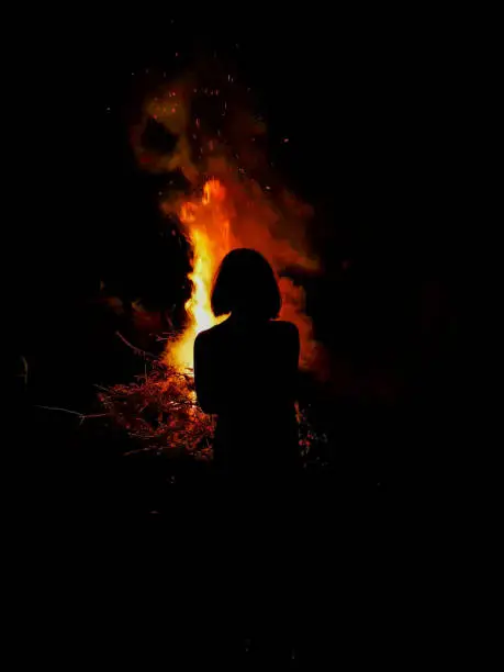 Photo of Young female in front of a fire