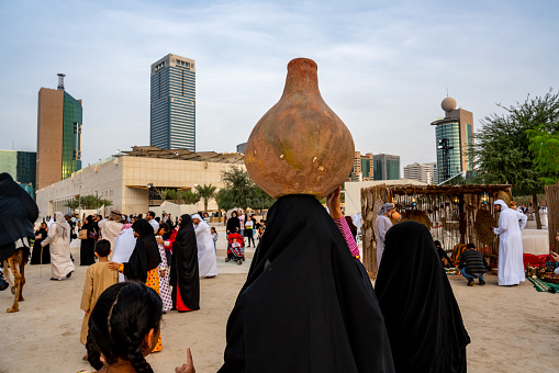 Arabian woman in traditional dress (Abaya) - Emirati dress - traditional and heritage celebrations - vintage and history\n- Abu Dhabi, UAE - December 23, 2019