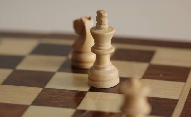 istock chess. chessboard and pieces on it. White background 1196994306