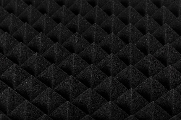 istock Sound proof Acoustic black gray foam absorbing, pyramid style padding layer panel for voice recording studio attach on wall as wallpaper background to reduce and protect sound to outside room. 1196995282