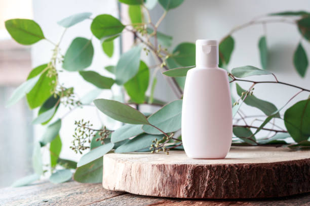 botella cosmética con hojas verdes de eucalipto. - diseño de baños con plantas fotografías e imágenes de stock