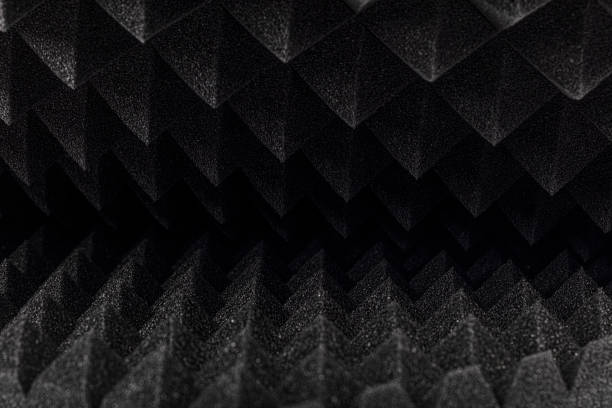 istock Sound proof Acoustic black gray foam absorbing, pyramid style padding layer panel for voice recording studio attach on wall as wallpaper background to reduce and protect sound to outside room. 1196998374