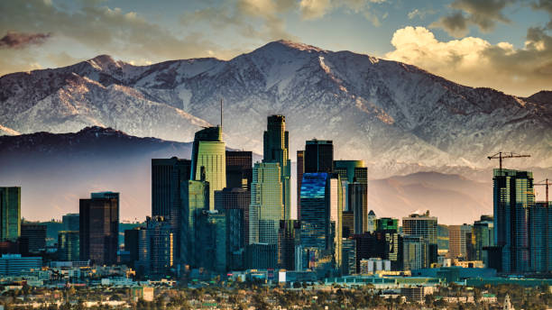 istock Downtown Los Angeles Skyline and Snowcapped mountains 1196998461