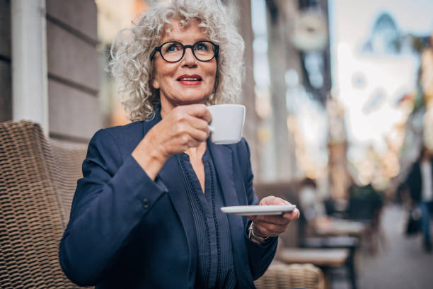 istock Beautiful senior woman drinking a hot drink 1196998497