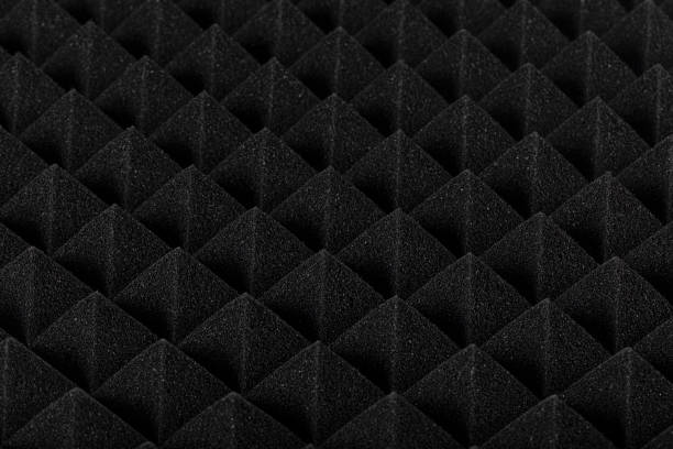 istock Sound proof Acoustic black gray foam absorbing, pyramid style padding layer panel for voice recording studio attach on wall as wallpaper background to reduce and protect sound to outside room. 1196998524