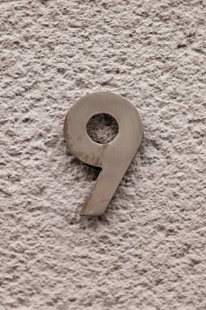 istock number 9 metal house number on stone wall 1196999421