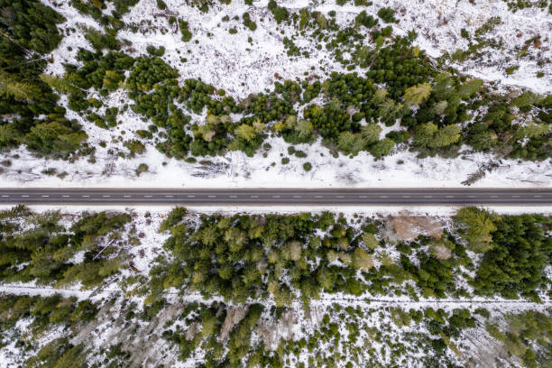 istock road in snow covered forest, top down aerial view 1196999523