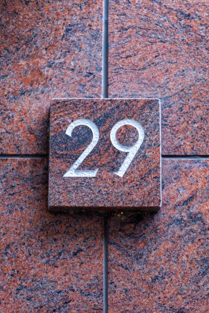 istock number 29 metal house number on stone wall 1196999536