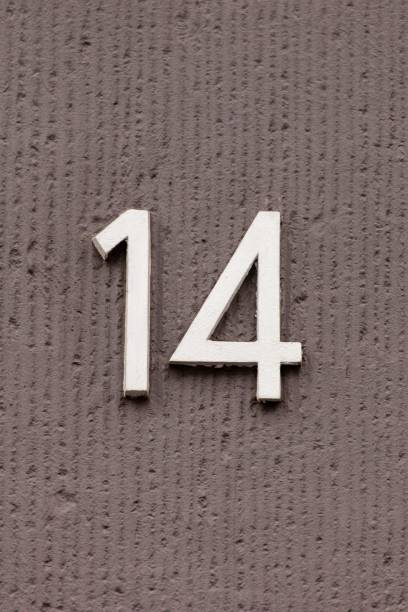 istock number 14 metal house number on stone wall 1197000131