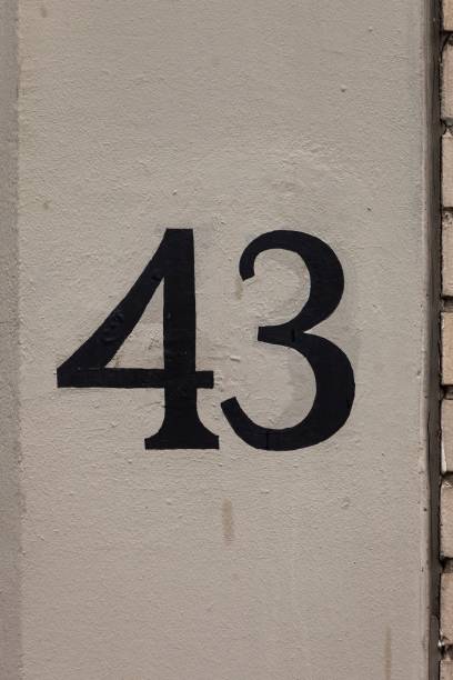 istock number 43 vintage hand painted house number on stone wall 1197000175
