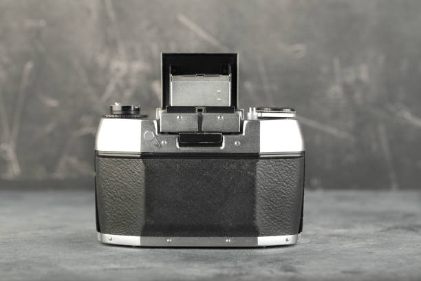 istock The old 35 mm SLR camera with lens on a grey cement background. 1197000355