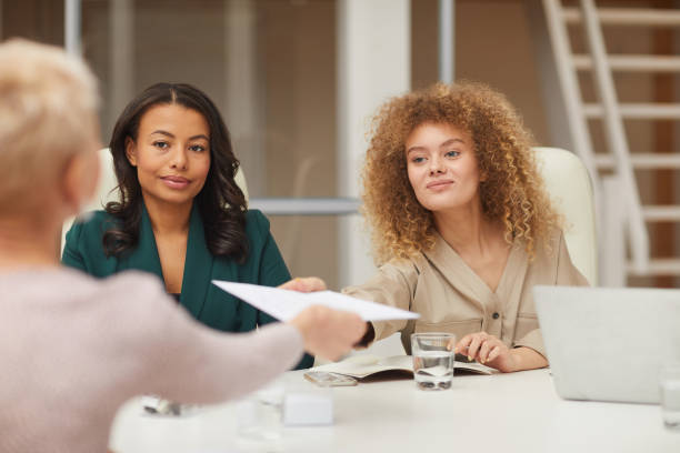 istock Businesswoman Sharing Document With Colleague 1197000473