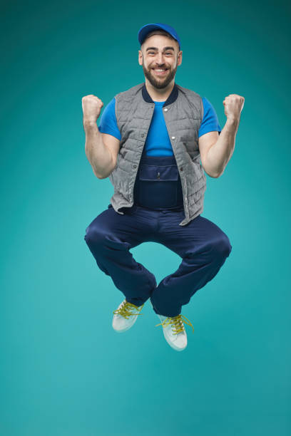 istock Cheerful Guy In Workwear Jumping 1197001308
