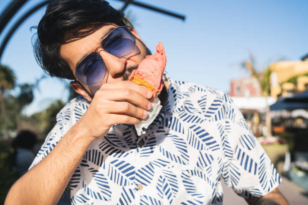 istock Man enjoying sunny weather while eating an ice cream 1197004561