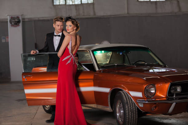 istock A couple in retro clothing standing with a car 1197006433