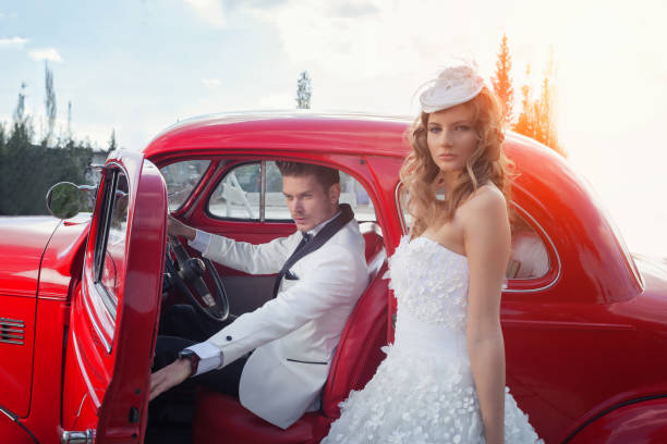 Happy bride and groom in the retro car